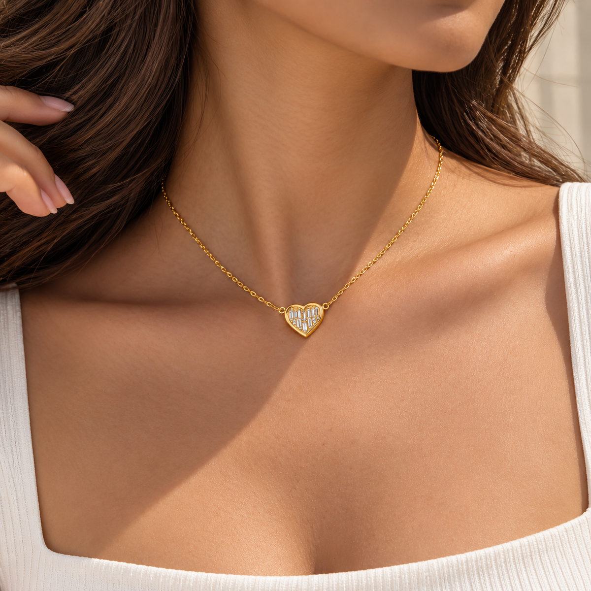 gold chain  anti tarnish 
necklace with a small heart-shaped pendant set with clear stones.